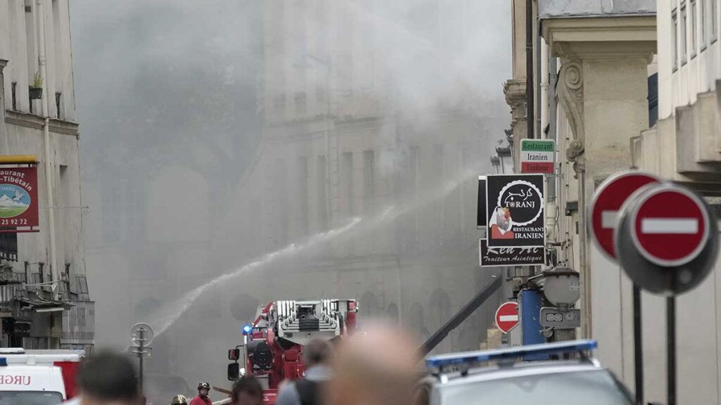 Bomberos combaten con un camión hidrante el incendio. AP